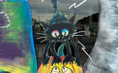 寺見建設のショウルームの窓アート、黒猫